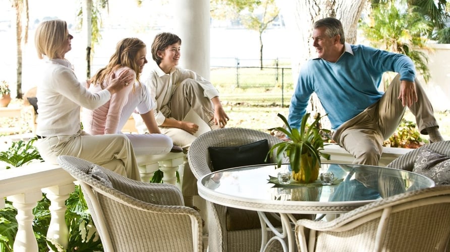 Happy family on a patio - mom, dad, and two teen kids